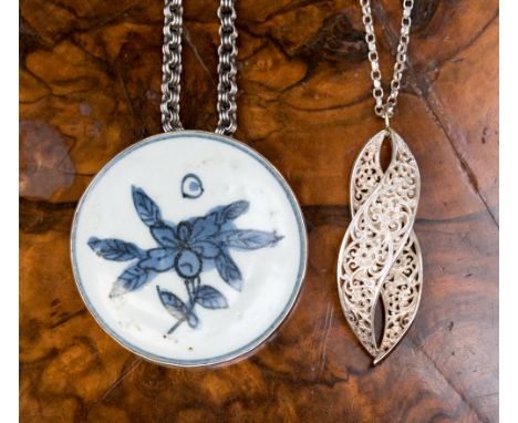 A large silver mounted circular pendant set Chinese pottery disc, blue painted flower and seal mark to the reverse, approx 7.