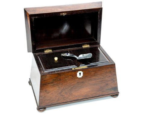 A mahogany tea caddy, standing on four bun feet, mother of pearl escutcheon 