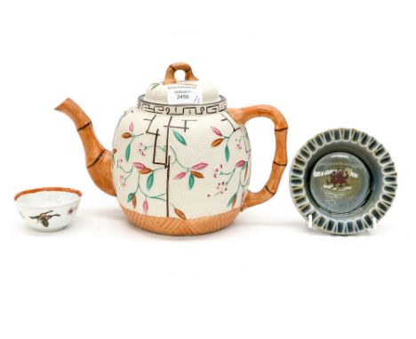 An Oriental style tea pot, having bamboo pattern handle, spout and finial, with tea bowl and Welsh dragon trinket dish (3)