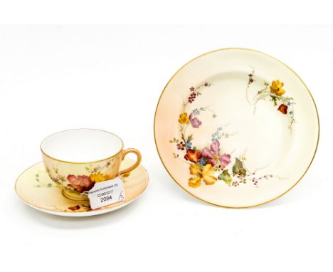 A Royal Worcester blush ivory trio, comprising cup saucer and side plate, each piece hand painted with floral sprays, early 2