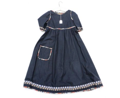A mid 1970s black wool dress by design label Francess Haigh, decorated with cotton floral edging on the neckline, sleeves, pa