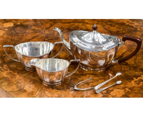 A George V silver three piece tea service to include teapot with Bakelite handle and finial, sugar bowl and milk jug, Barker 