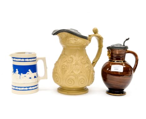 A Wedgwood Doric jug with metal lid, a Copeland late Spode jug and another mid 19th century jug with pewter lid (3)