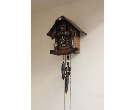 A Cuckoo clock with weights, etc 