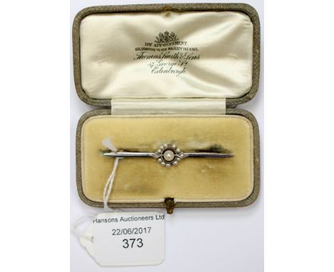 A natural pearl, seed pearl white and yellow metal bar brooch with two small diamonds set either side of a central pearl appr