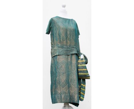 A teal coloured 1920s cocktail dress with an 'A' design with a wide pleated sash, the fabric is threaded with fine gold threa