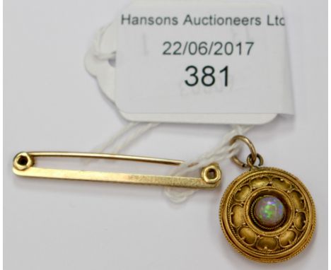 A gilt metal mourning pendant, set with opal, having bevelled glass to reverse, with a 15ct gold tie pin, weighing approx 2.1