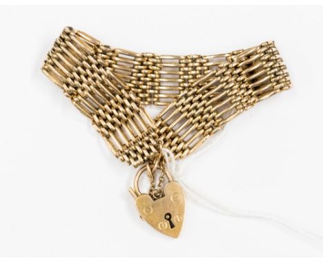 A 9ct seven bar gate bracelet with padlock clasp, approx 1.5cm wide with a length of 6.5'' and a weight approx 28.6 grams 