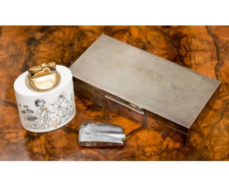 A silver table cigarette casket, Birmingham 1966, maker S.J. Rose, a Rosenthal Studio Line table cigarette lighter and a Rons