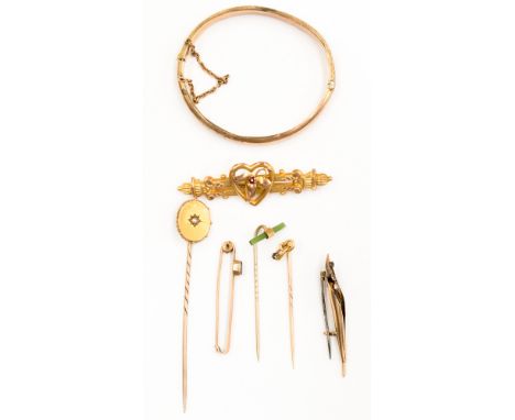 A collection of 9ct gold and yellow metal items including  a hinged  bangle, a bar brooch with heart detail and flower set wi