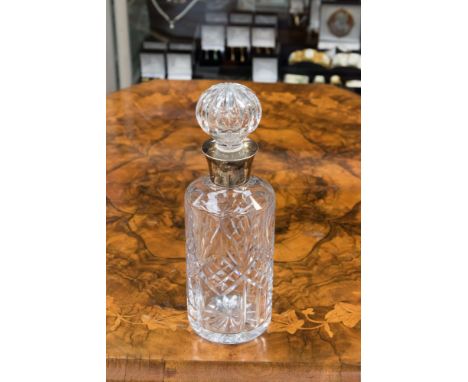 A cut glass decanter and stopper with silver collar, Birmingham 1979, maker S.J. Rose