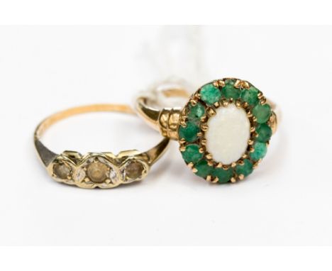 An opal and emerald ring, set with an oval white opal surrounded by twelve round emeralds, set in 9ct gold, size P, along wit