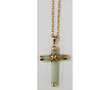 A 14ct gold and jadeite pendant approx 3cm x 2cm in size along with a 9ct gold chain approx 18'' long. 