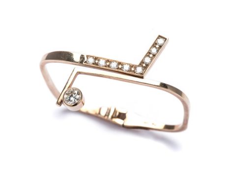 A 9K YELLOW GOLD AND DIAMOND BANGLE a hinged bangle with a tube set round brilliant-cut diamond weighing approximately 0.75ct