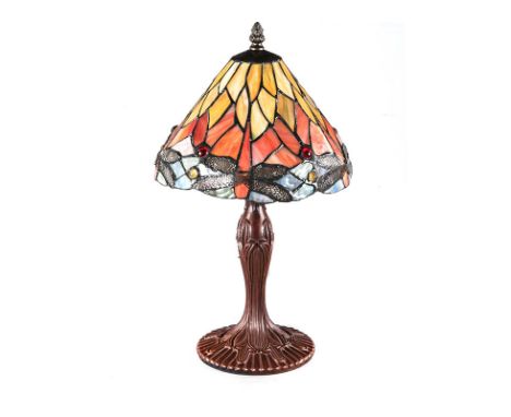 AN ART NOUVEAU STYLE LAMP, 20TH CENTURY the shaped colourful shade surmounted by a finial, above a metal support, fitted for 