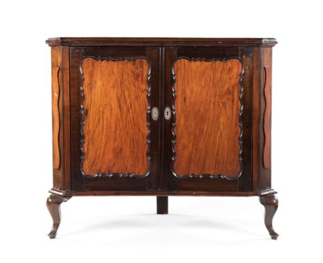 A CAPE STINKWOOD AND BEEFWOOD CORNER CUPBOARD, LATE 18TH/EARLY 19TH CENTURY the rectangular moulded top with canted corners a