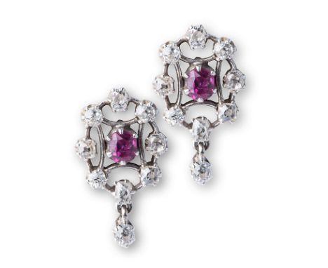 A PAIR OF 18K WHITE GOLD, RUBY AND DIAMOND CLUSTER EARRINGS each ruby surrounded by eight old cut diamonds with one diamond s