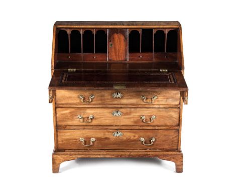 A GEORGE III MAHOGANY BUREAU the rectangular top above a hinged fall-front enclosing drawers and compartments, in sizes, a fr