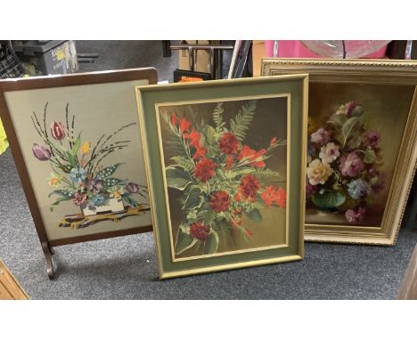 Two framed paintings depicting flowers and a framed wooden tapestry largest measures approximately 13 inches tall x 26 wide