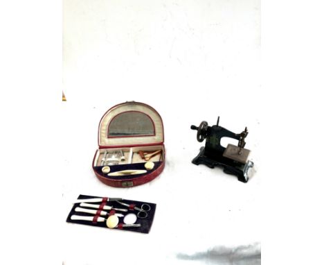 Vintage miniature sewing machine and a vintage manicure set 