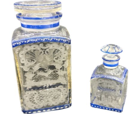 Two vintage blue rimmed lidded jars with etched oriental scenes largest measures approximately 8 inches tall, small jar has s