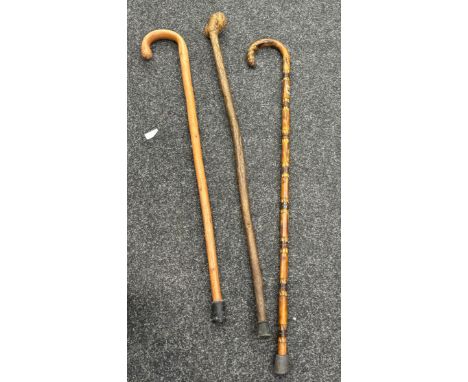 Three vintage wooden walking sticks, tallest measures 36 inches