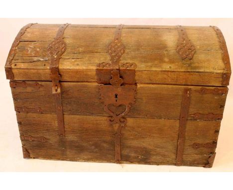 A 17th Century iron bound oak domed trunk
Flanked by twin carrying handles, some restoration and further damage throughout, w