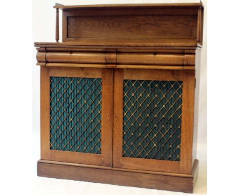 A Regency period light oak chiffonier 
The raised back applied with pierced gilt metal three quarter gallery, above two ovolo