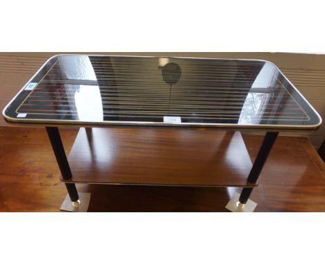 A circa 1970's rectangular coffee table having magazine shelf under tier.