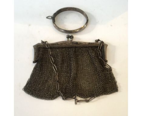 A Birmingham hallmarked silver bangle, together with a Birmingham hallmarked silver topped chain ladies bag/purse (2).