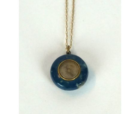 An early 20th Century hardstone miniature compass of circular form
Complete with gold-plated necklace.