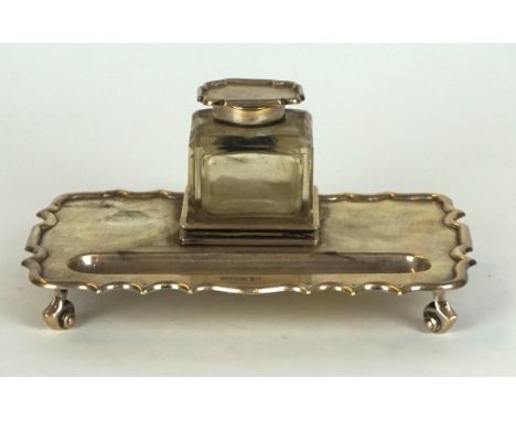A George V hallmarked silver rectangular desk stand having detachable glass inkwell with hallmarked silver collar and cover, 