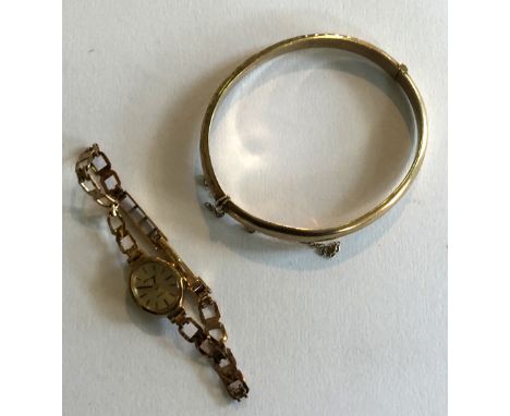 A 9ct gold hollow hinged bangle, together with a 9ct gold Accurist quartz bracelet watch, gold weight approx 14.6gms (watch a