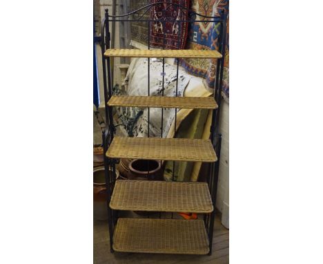 A modern folding metal and wicker storage shelf unit.