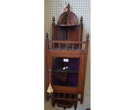 An early 20th Century mahogany hanging corner cabinet, having single glazed door enclosing fixed shelf.