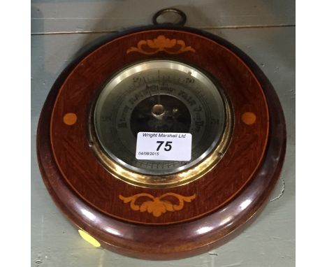 An Edwardian inlaid mahogany circular barometer. 