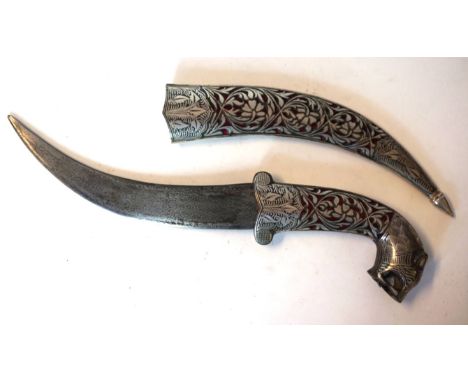 An late 19th Century ornamental Turkish knife
The 17cm curved blade with white metal inset decoration, with white metal inlai