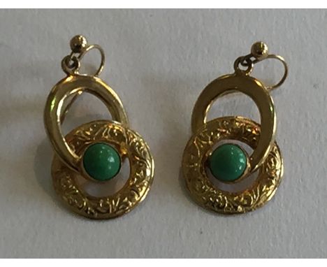 A pair of 9ct gold and jade mounted earrings.