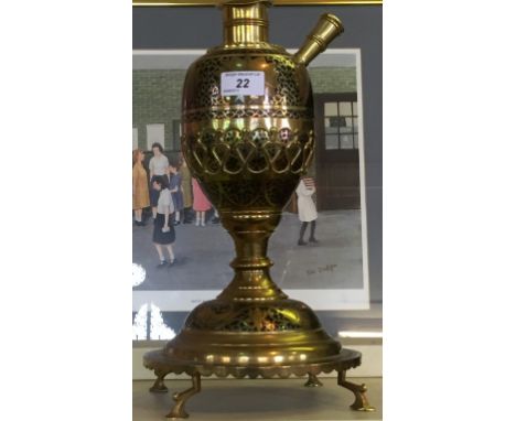 A 20th Century eastern brass Hookah pipe base, having floral and stylised decoration depicting fish.