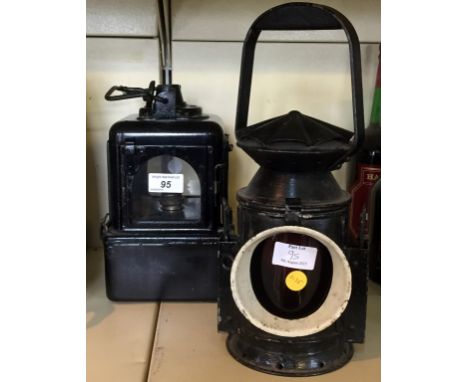 A vintage carriage lamp together with a further vintage travelling lamp.