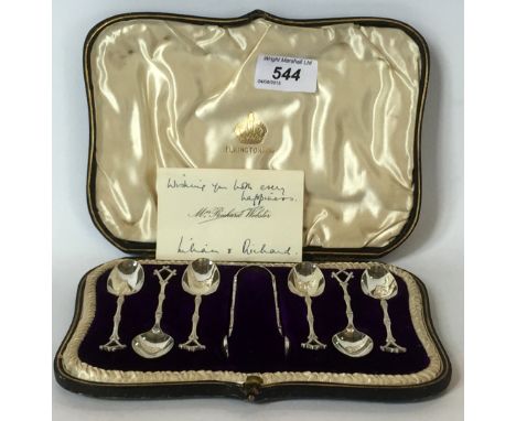 A cased set of Birmingham hallmarked silver tea spoons and sugar tong made by Elkington & Co, the teaspoon handle modelled in