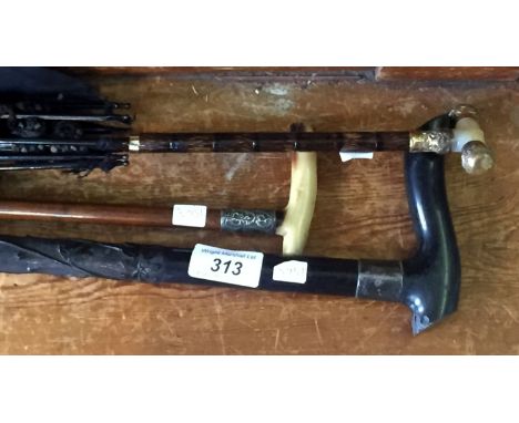 An early 20th Century ebony walking cane with hallmarked silver ferule,and a horn handled walking cane with hallmarked silver
