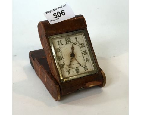 A Jaegar la Coultre travelling clock set within leather case.
