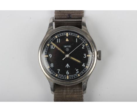 A Smiths MoD issue steel cased gentleman's wristwatch, the signed black dial with Arabic hours, centre seconds and MoD arrow,