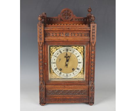 A late 19th century oak mantel clock with eight day movement striking on a gong, the backplate stamped 'W &amp; H Sch' (Winte