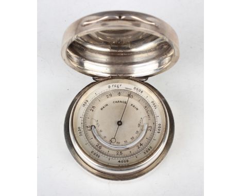 A late Victorian silver circular cased pocket aneroid barometer, the silvered dial with curved alcohol thermometer, the cylin