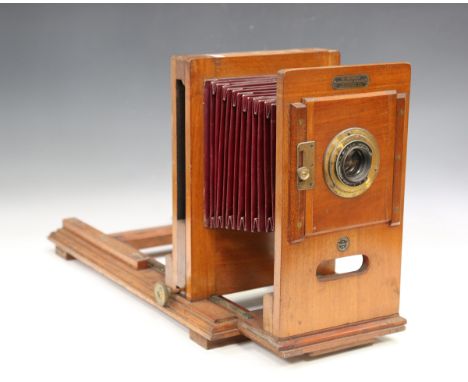 A late 19th century Westminster Photographic Exchange mahogany and gilt brass enlarger with red leather bellows, height 33.5c