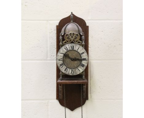 A 20th century brass lantern clock with Franz Hermle weight driven movement striking on a bell, the dial with engraved decora