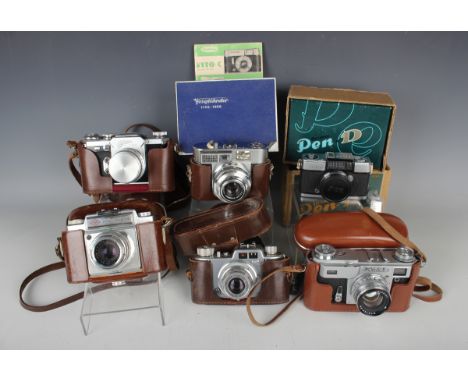 A collection of assorted cameras, including Canon Model VT camera with f:1.8 50mm lens, Voigtländer Vitomatic II camera, boxe