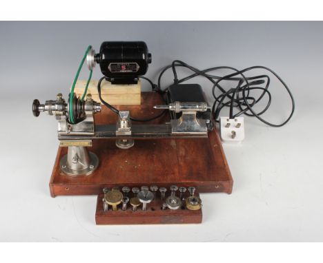 An IME 8mm watchmaker's lathe, No. 650, and attachments, together with a pinion cutting machine and a modern depthing tool.Bu